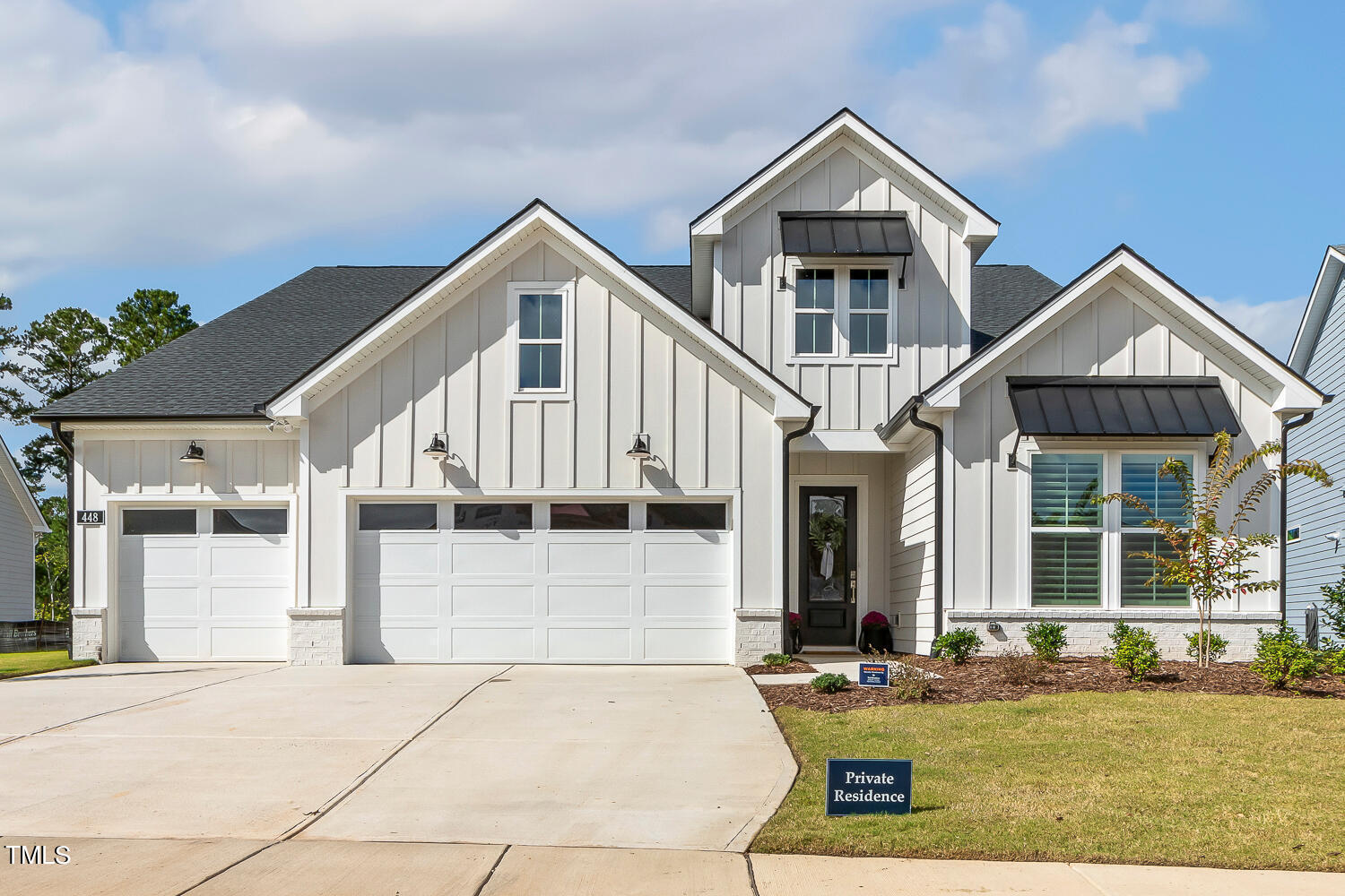 a front view of a house with garage