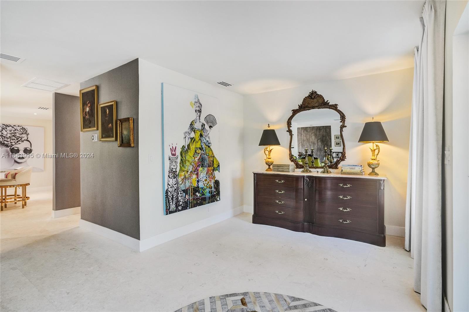 a living room with furniture and painting on the wall