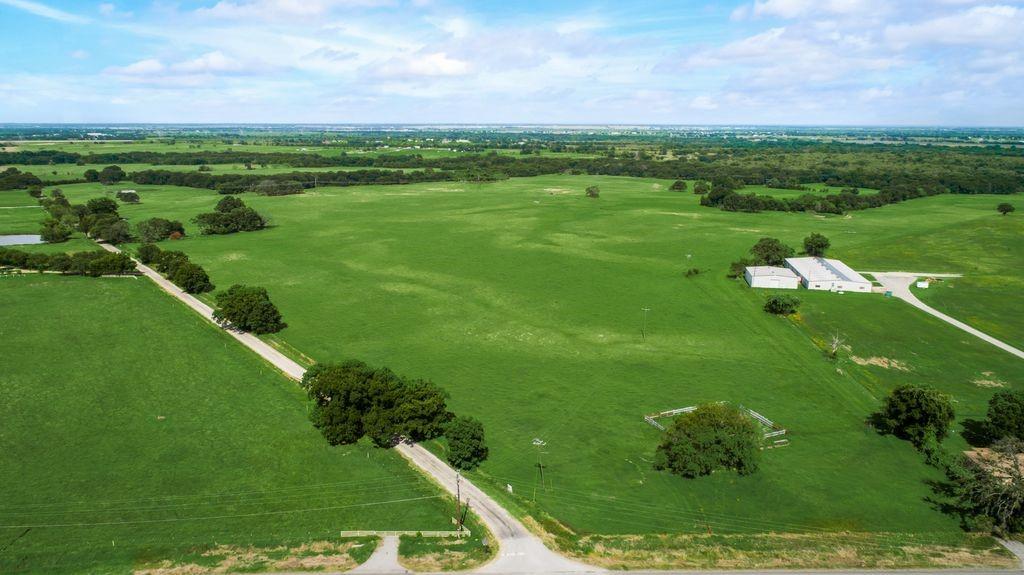 a view of a green field with an ocean