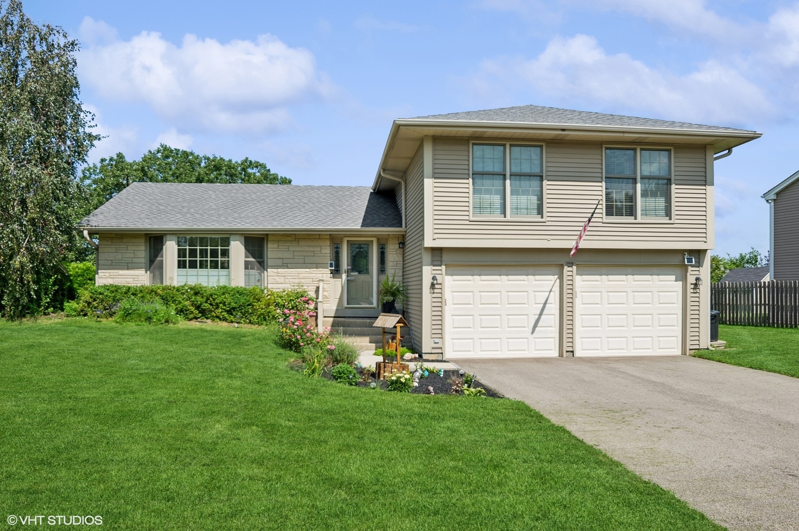 a front view of a house with a garden and yard