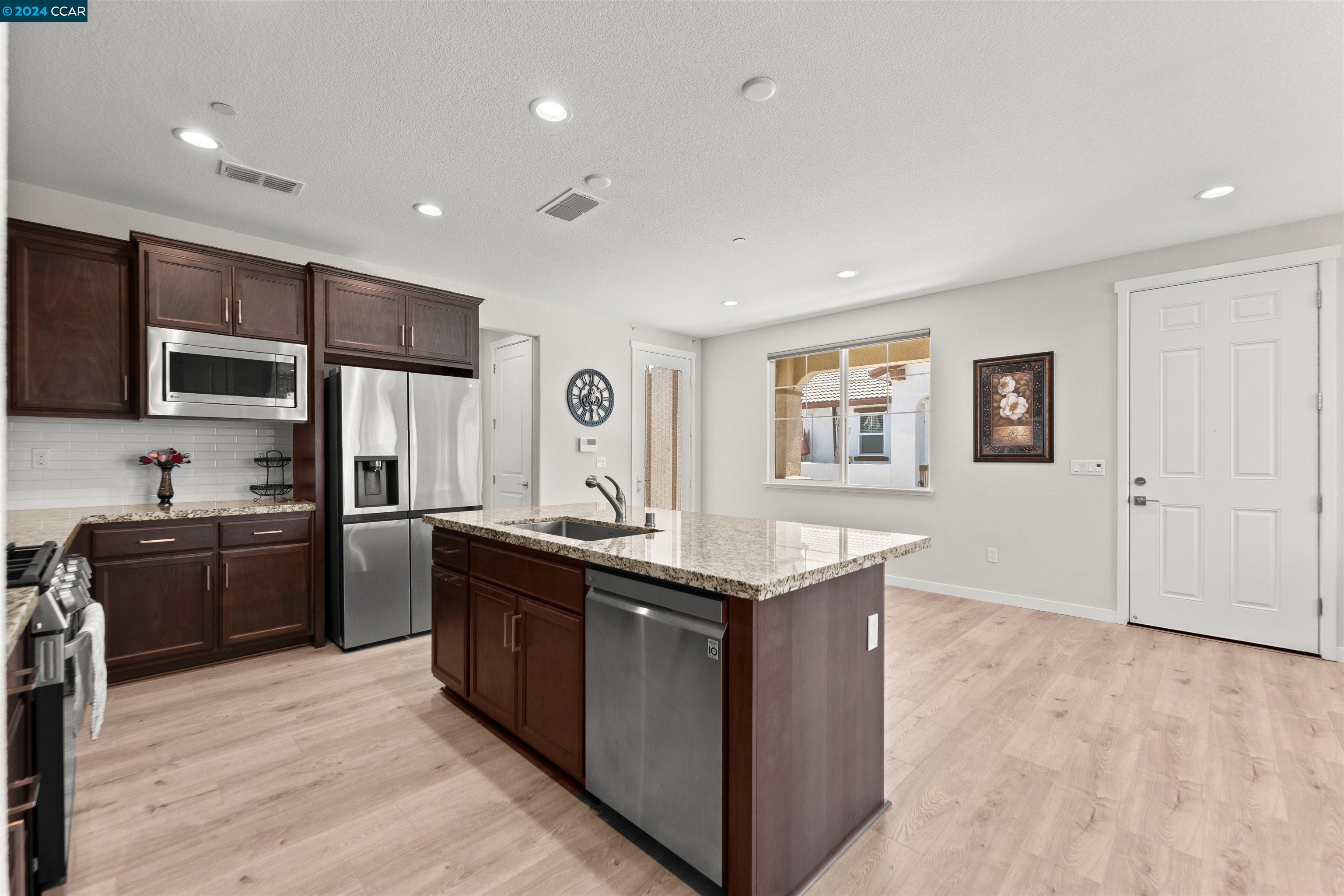 a kitchen with stainless steel appliances granite countertop a stove and a refrigerator