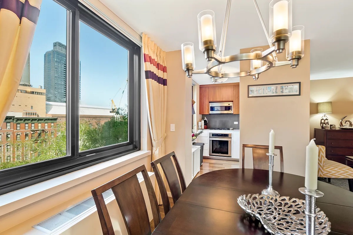 a view of a living room with furniture and large window