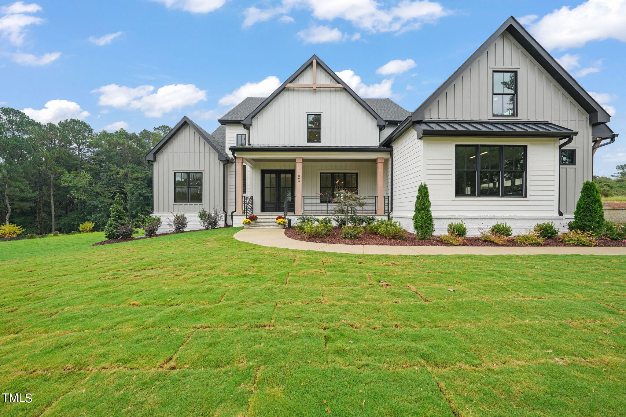 a front view of house with yard and outdoor seating