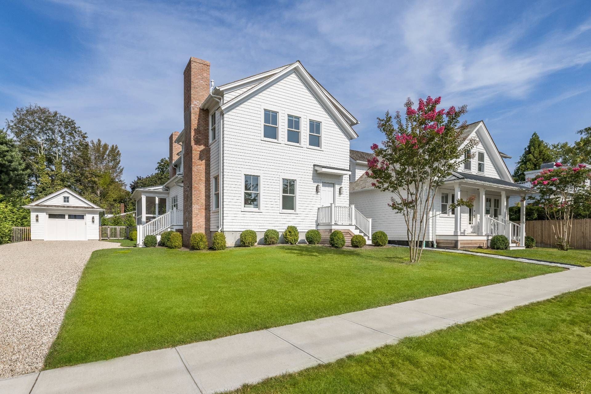 a front view of a house with a garden