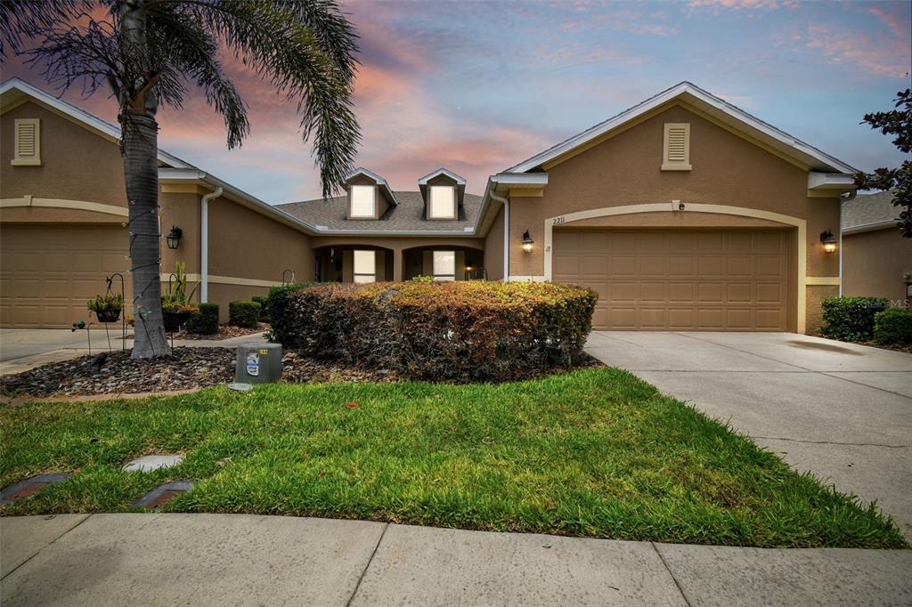 a front view of a house with a yard and garage