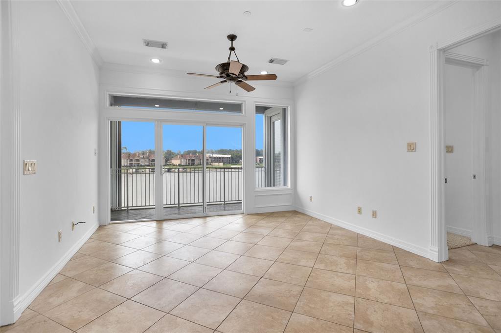 a view of a livingroom with a ceiling fan and window