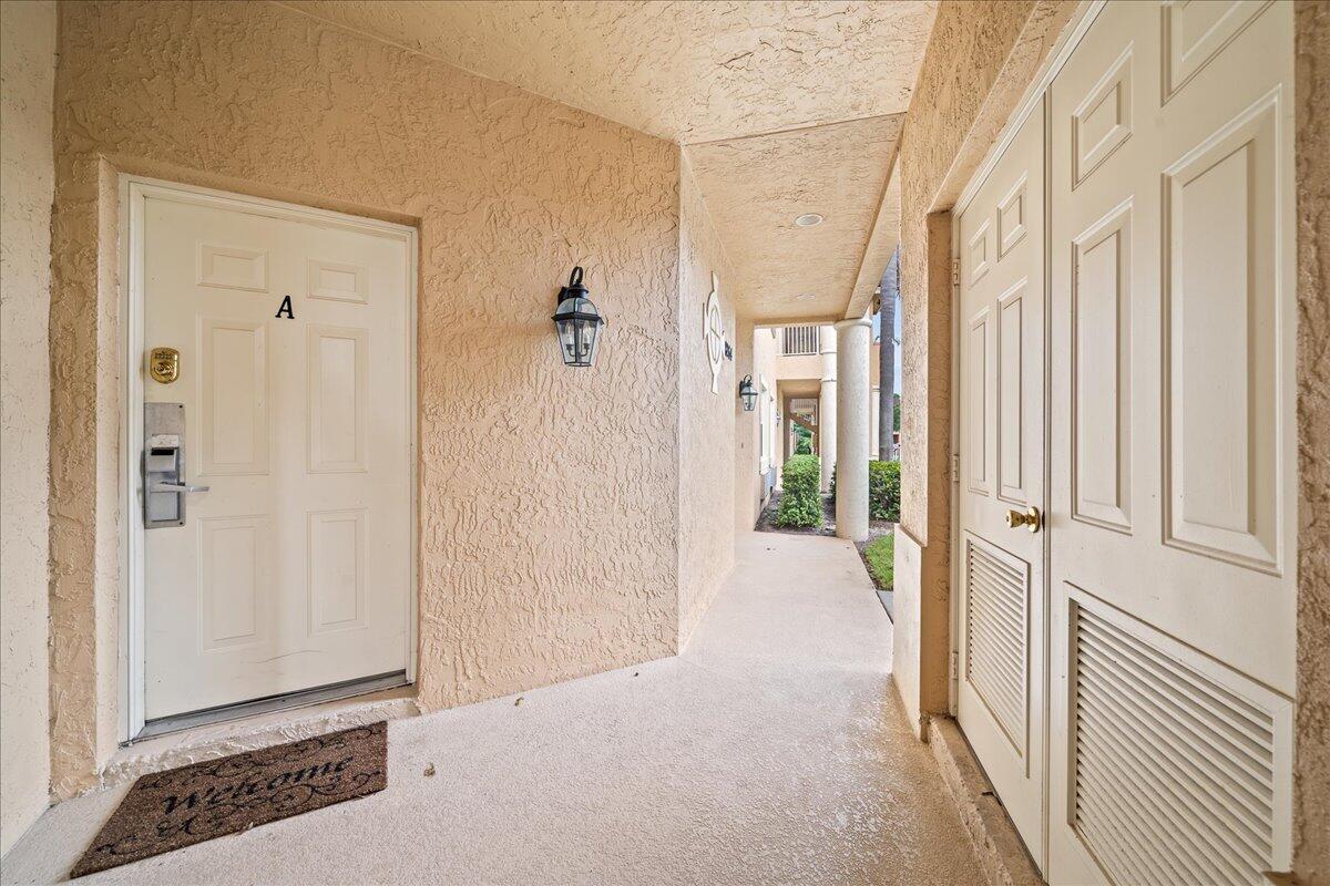 a view of a hallway with wooden floor and closet area