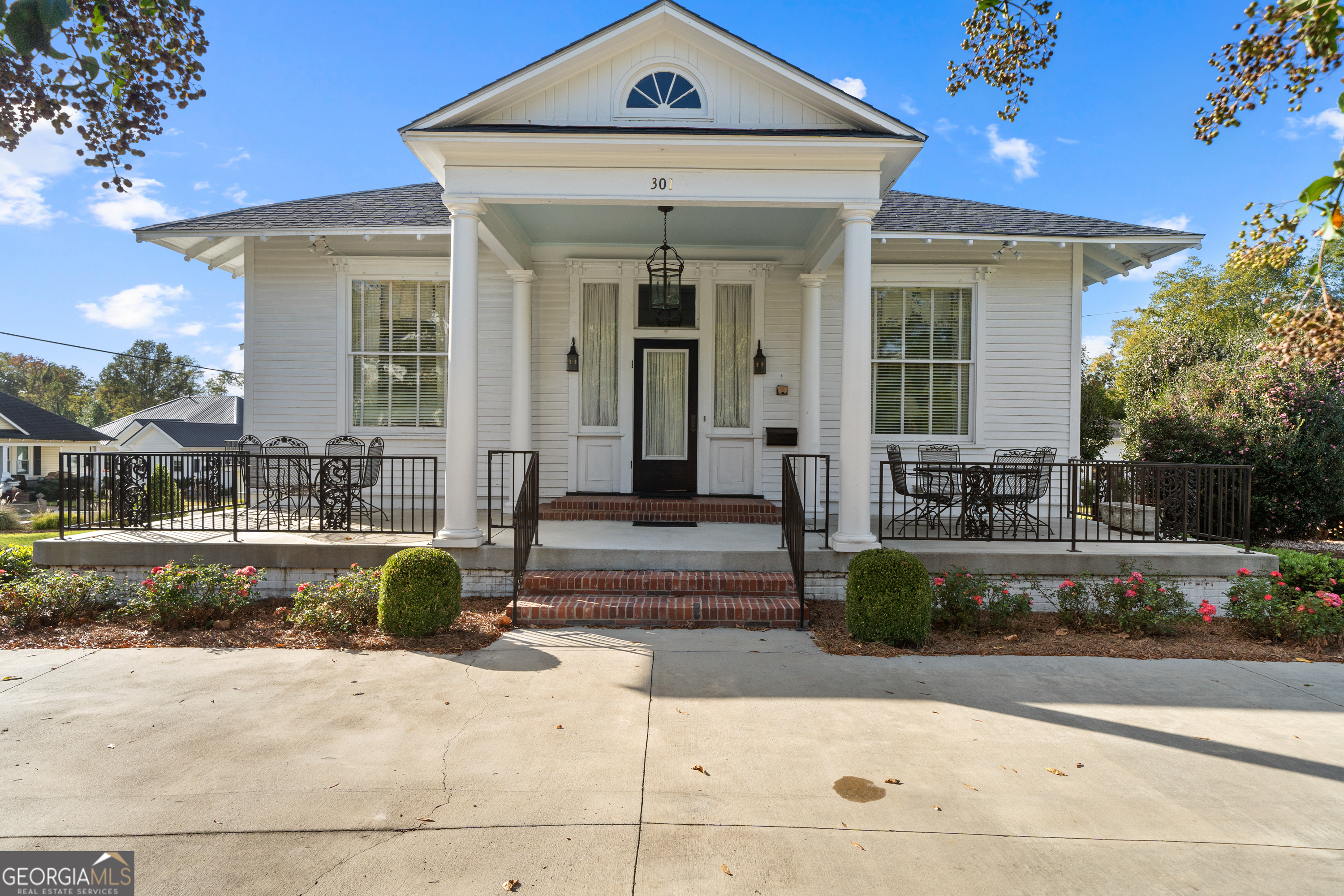 a front view of a house with garden