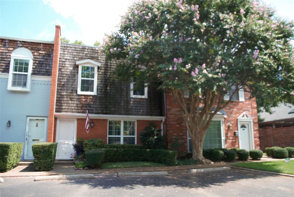 a front view of a house with a yard and a garage