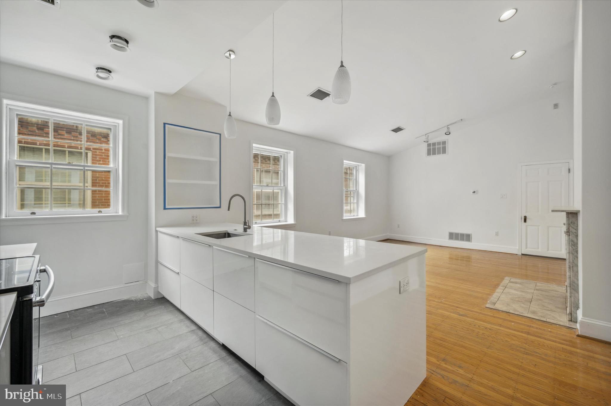 a large white kitchen with a large window