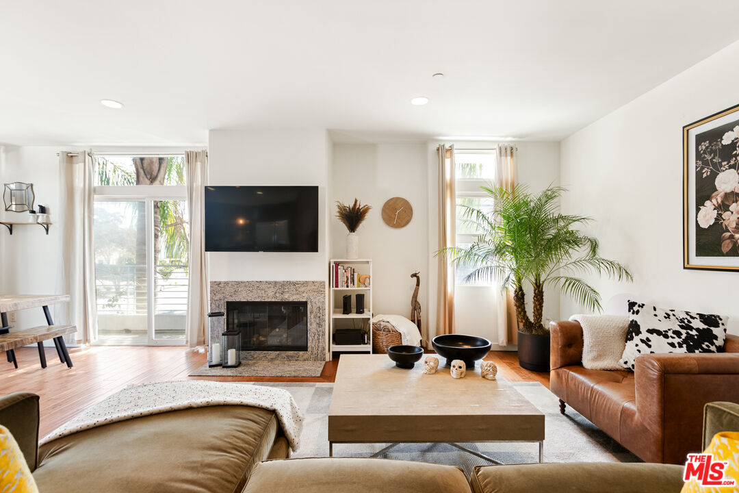 a living room with furniture fireplace and flat screen tv