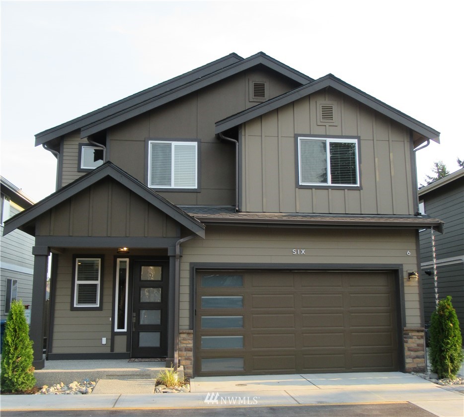 a front view of a house with garage