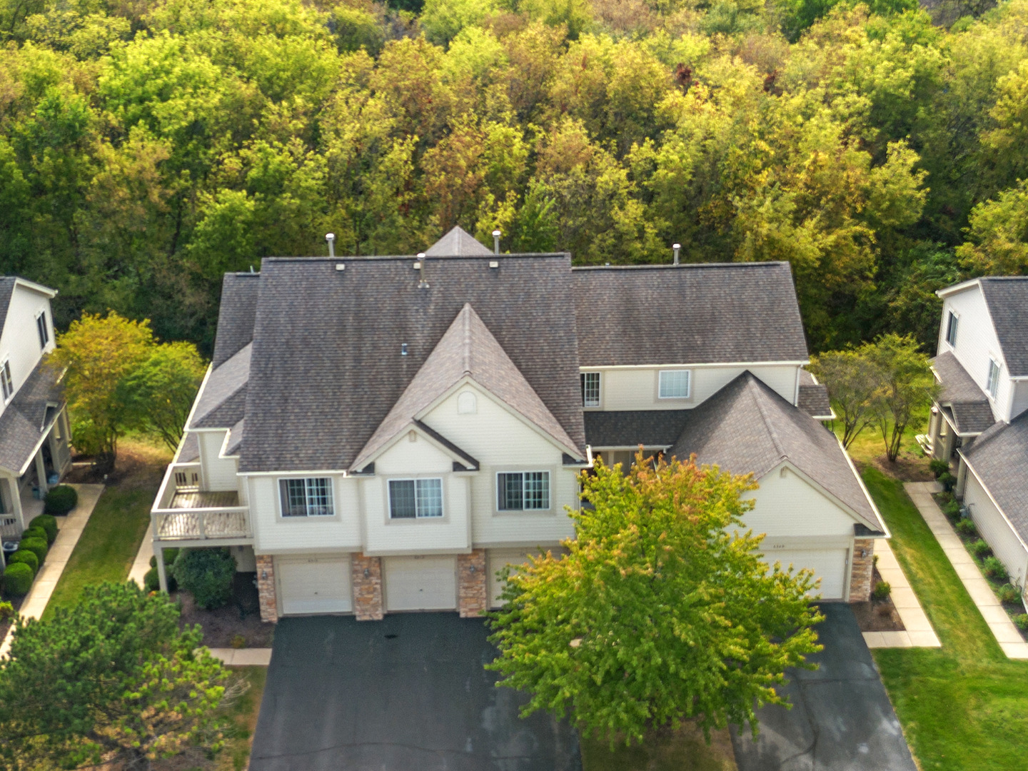 an aerial view of a house with a yard table and chairs