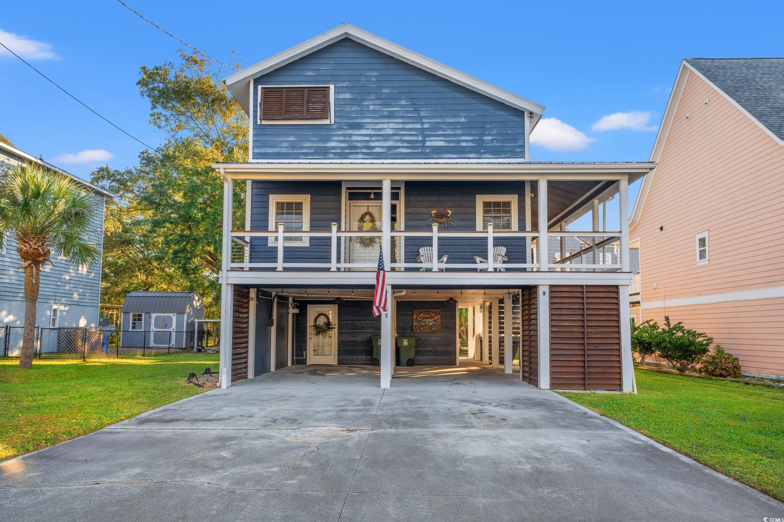 View of front property with a carport, a porch, an