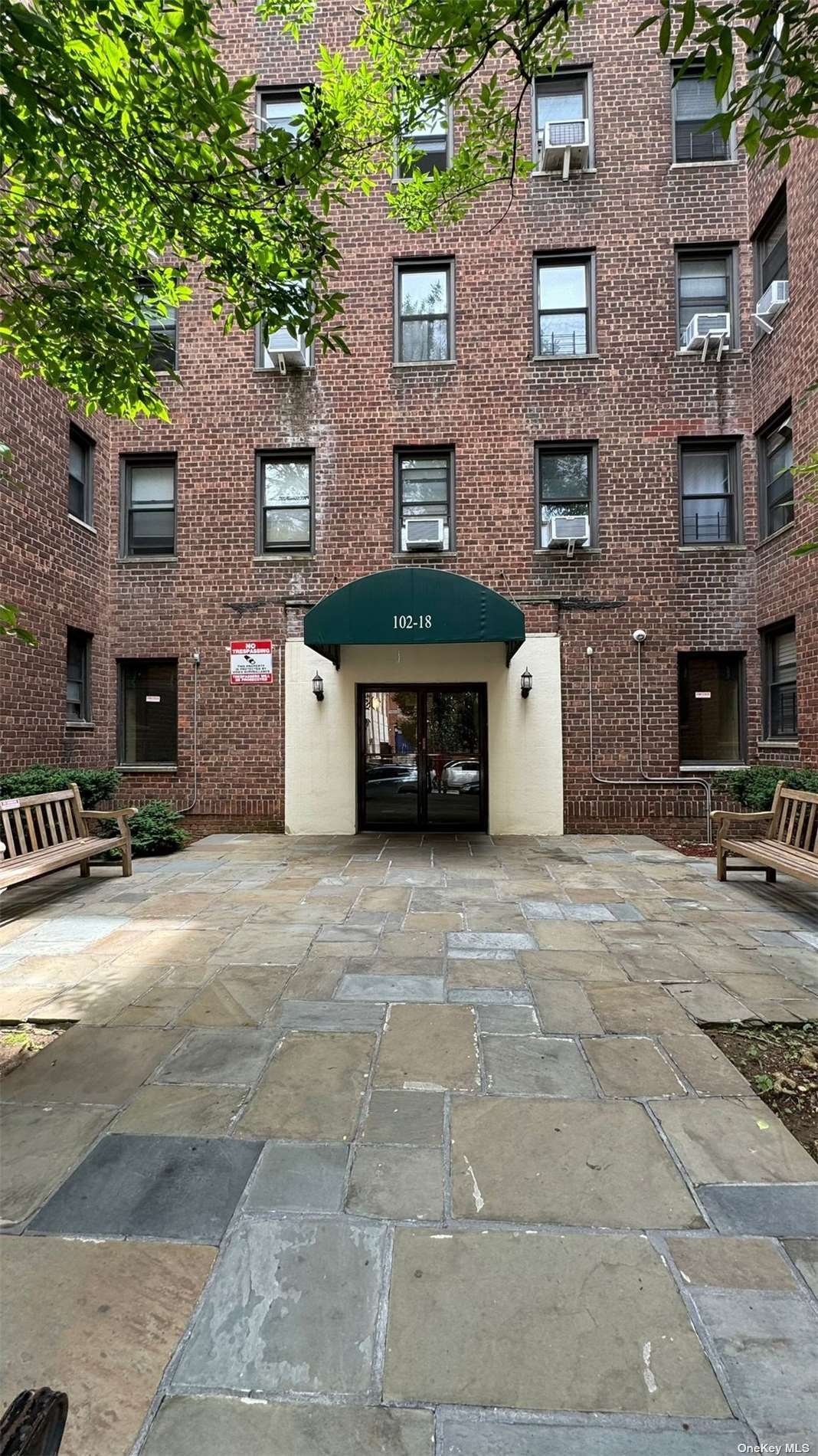 a front view of a building with parking area