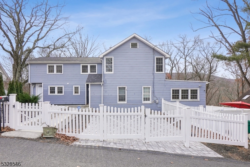 a front view of a house with a fence