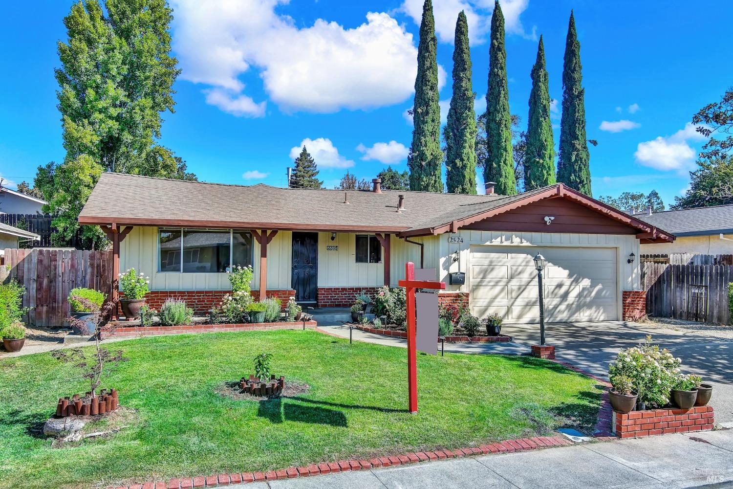 a view of a house with a yard and plants