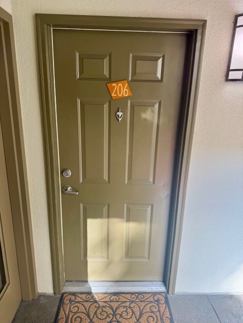 a view of a hallway with wooden floor and a glass door