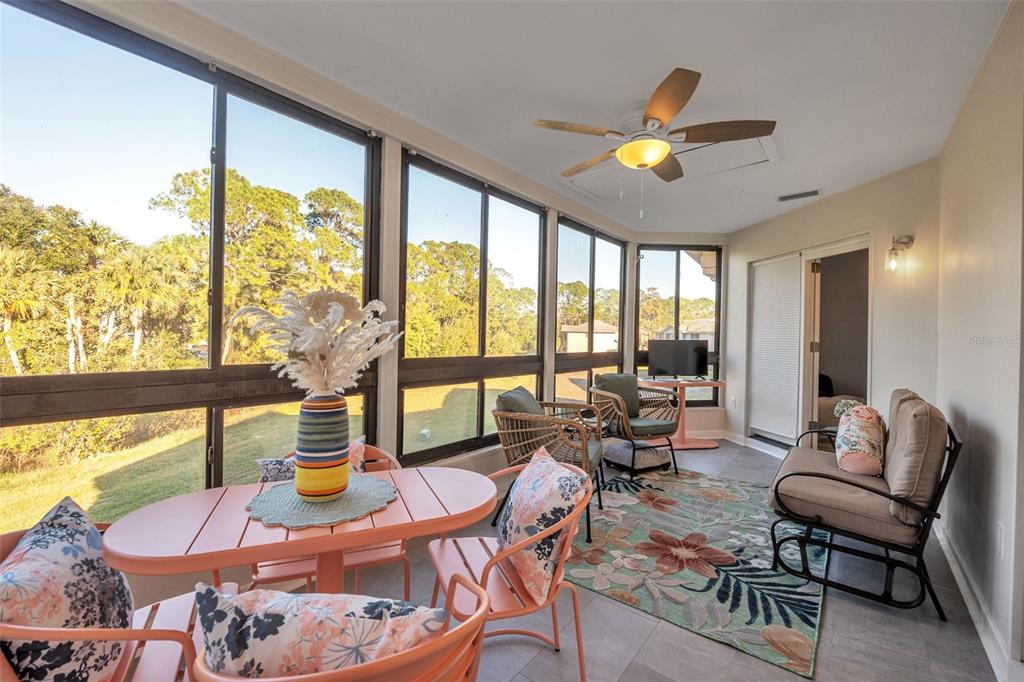 a living room with furniture and floor to ceiling windows