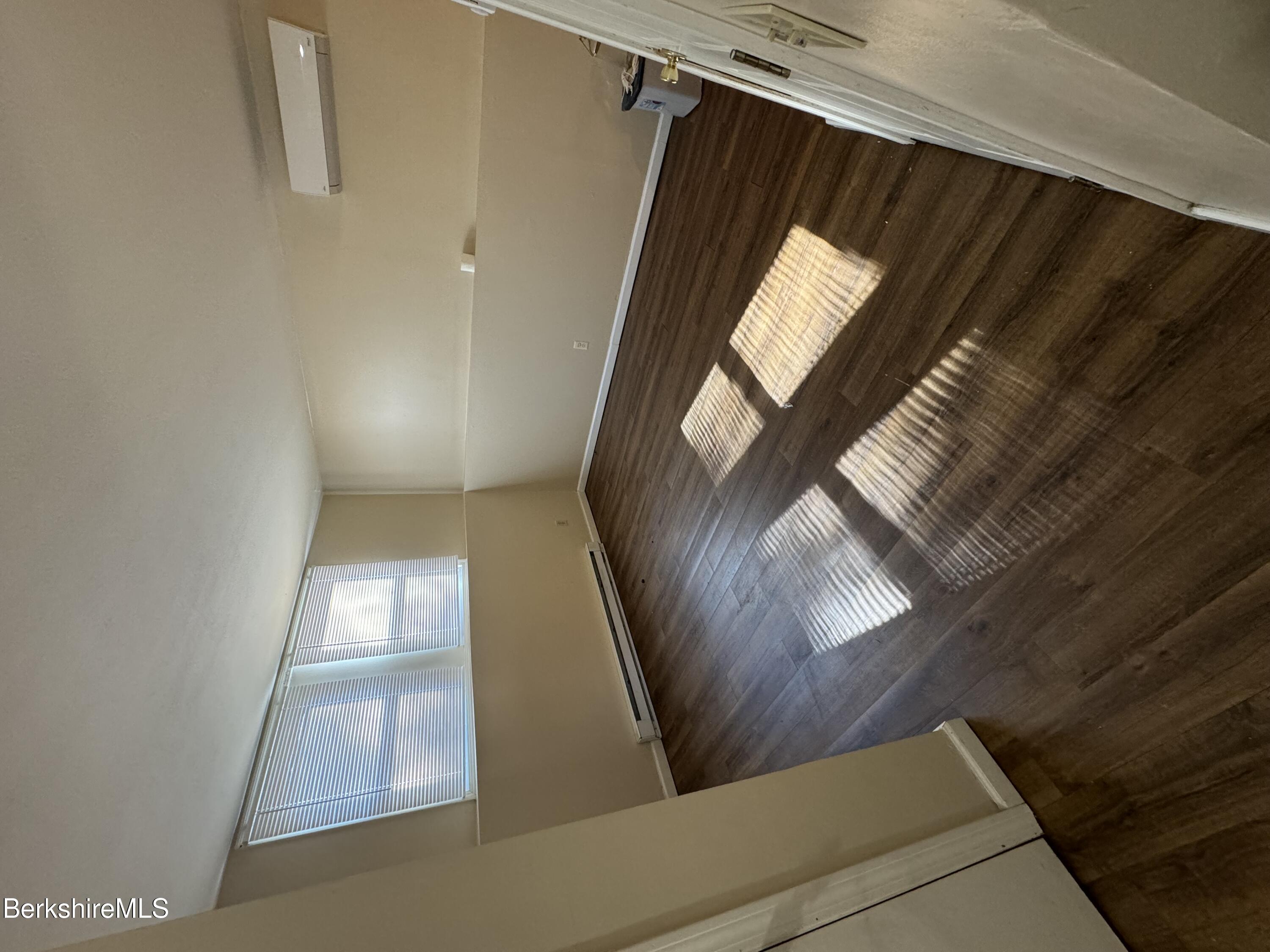 a view of wooden floor and windows in a room