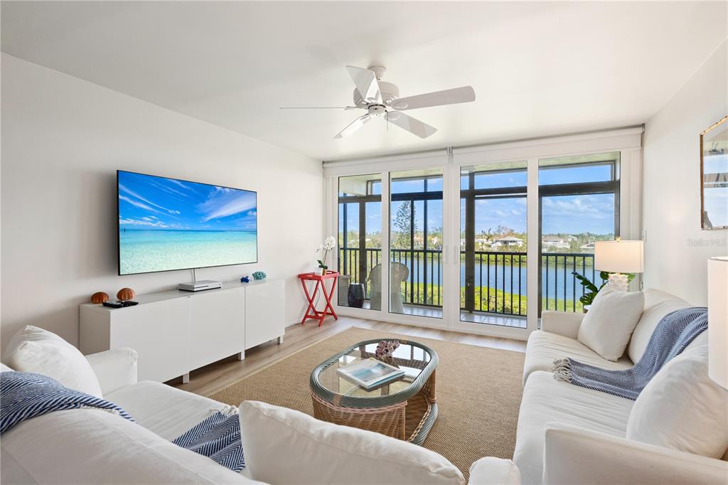 a living room with furniture and a floor to ceiling window