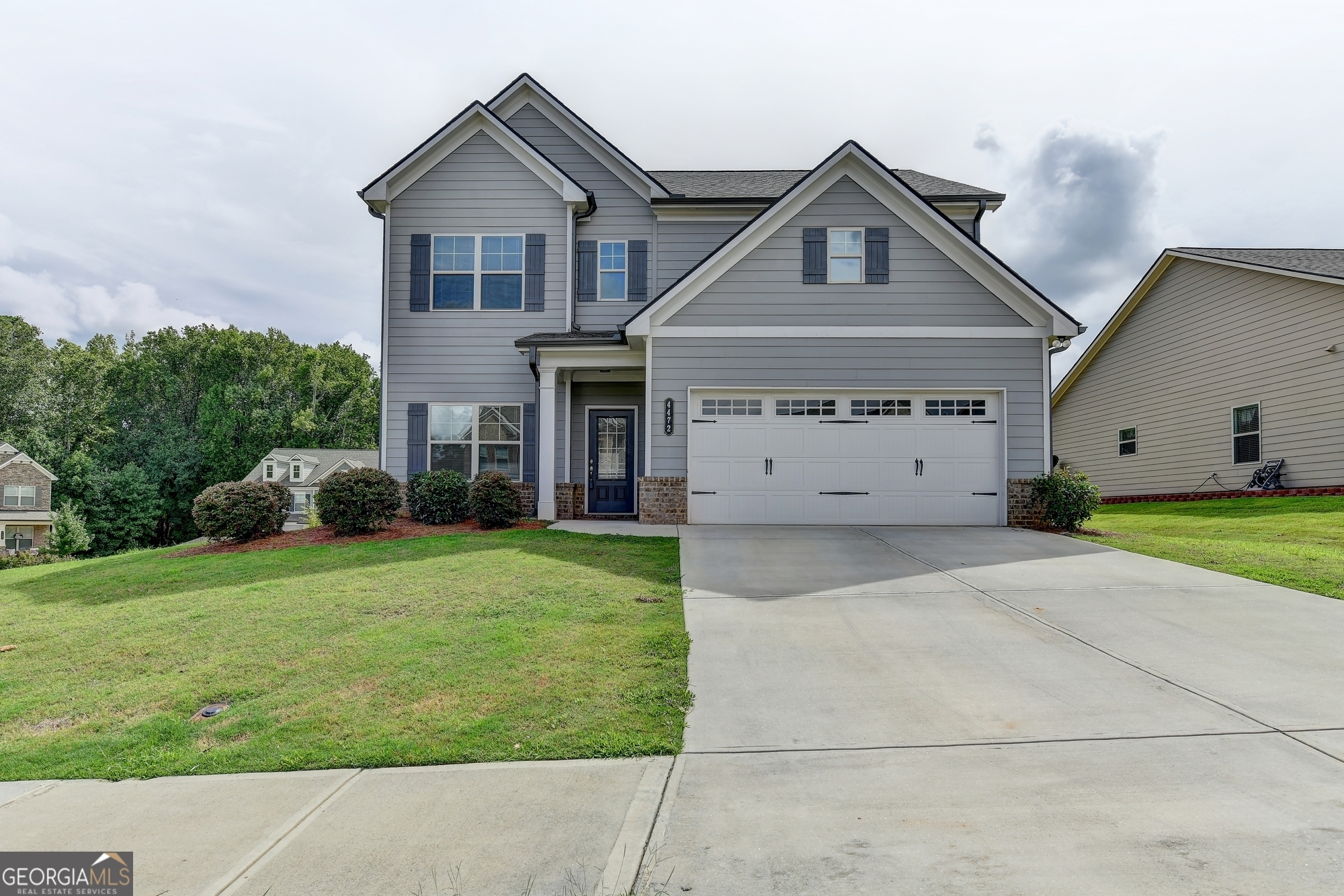 a front view of a house with a yard and garage