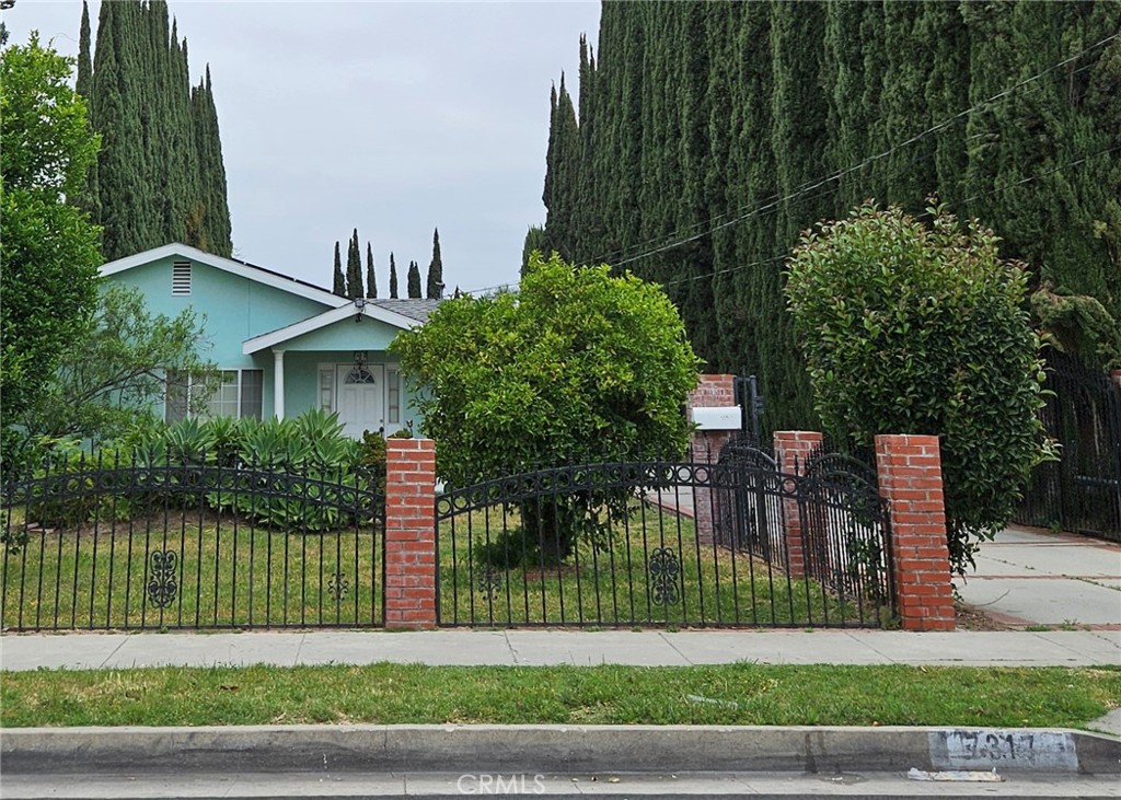 a front view of a house with a garden and plants