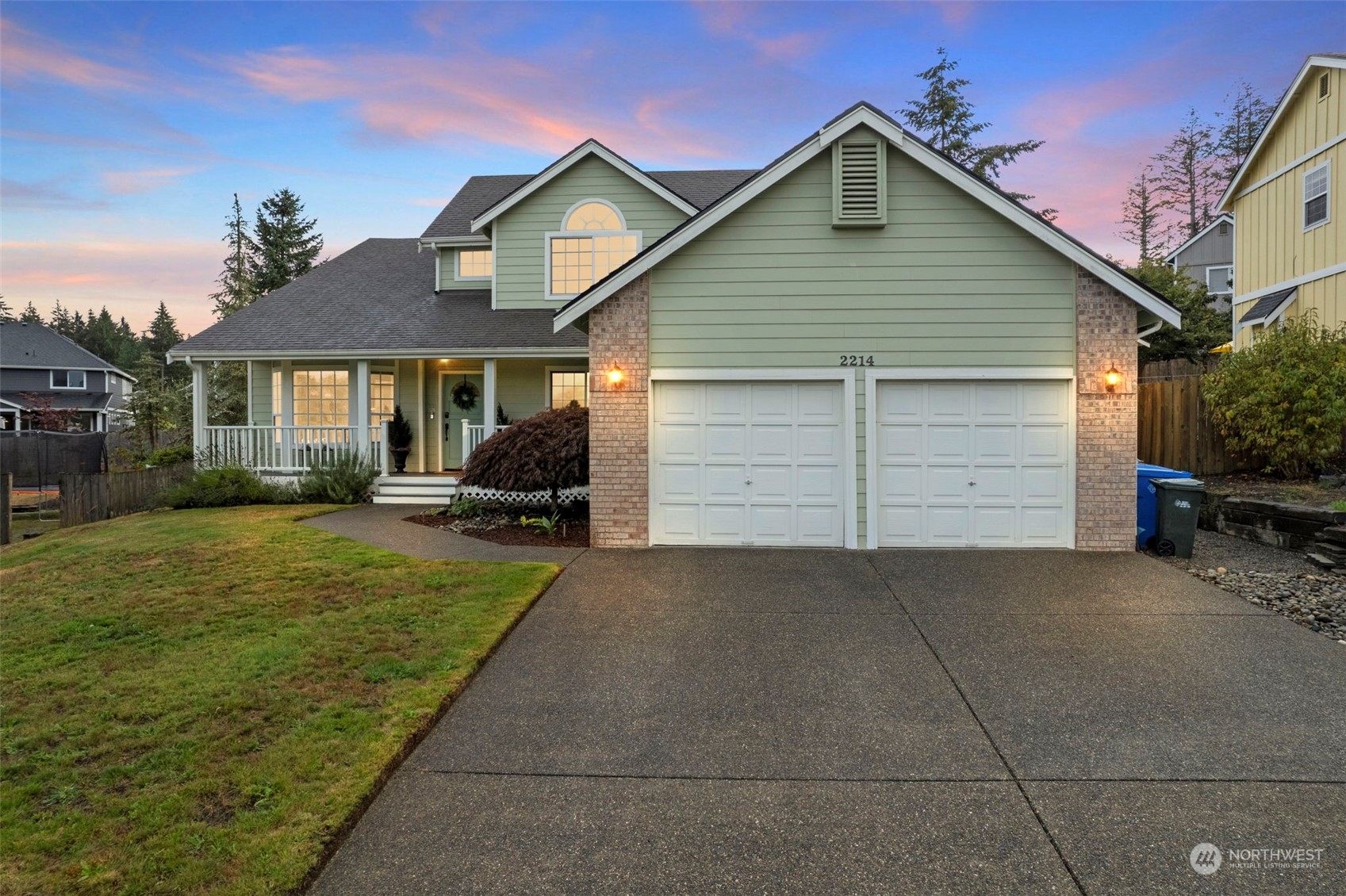 a view of house and yard with a garage