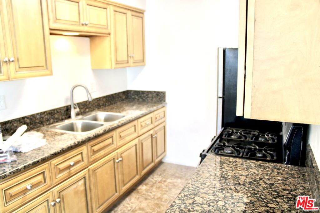 a kitchen with sink and cabinets