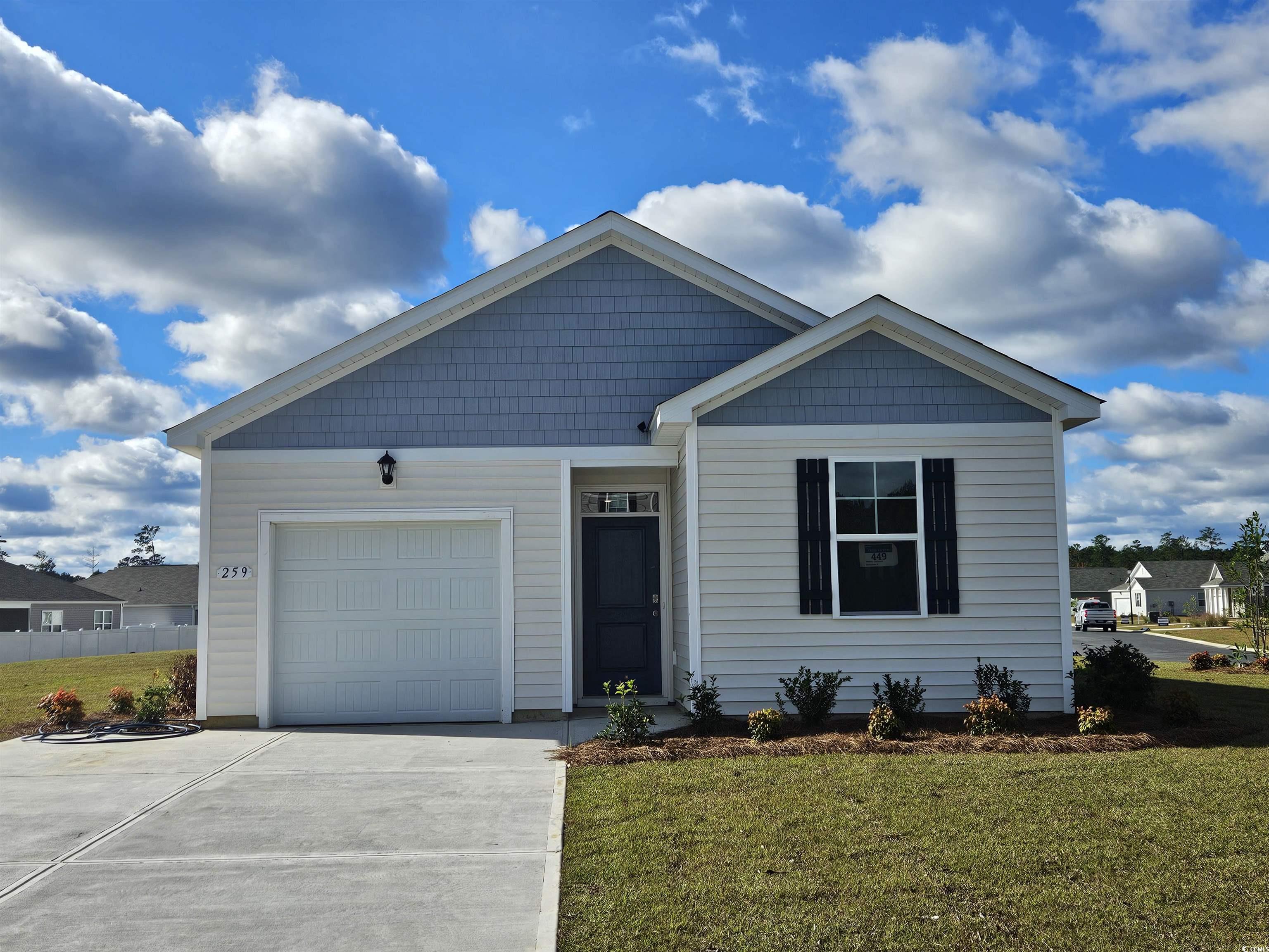 View of front of property featuring a front lawn a