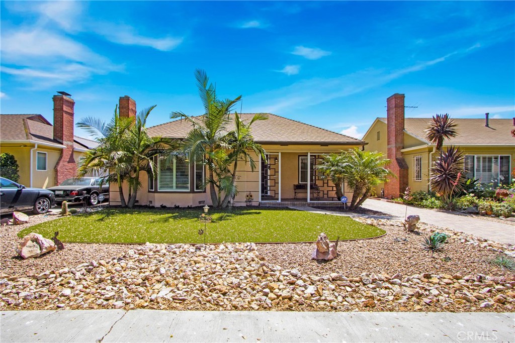 a front view of a house with swimming pool having outdoor seating