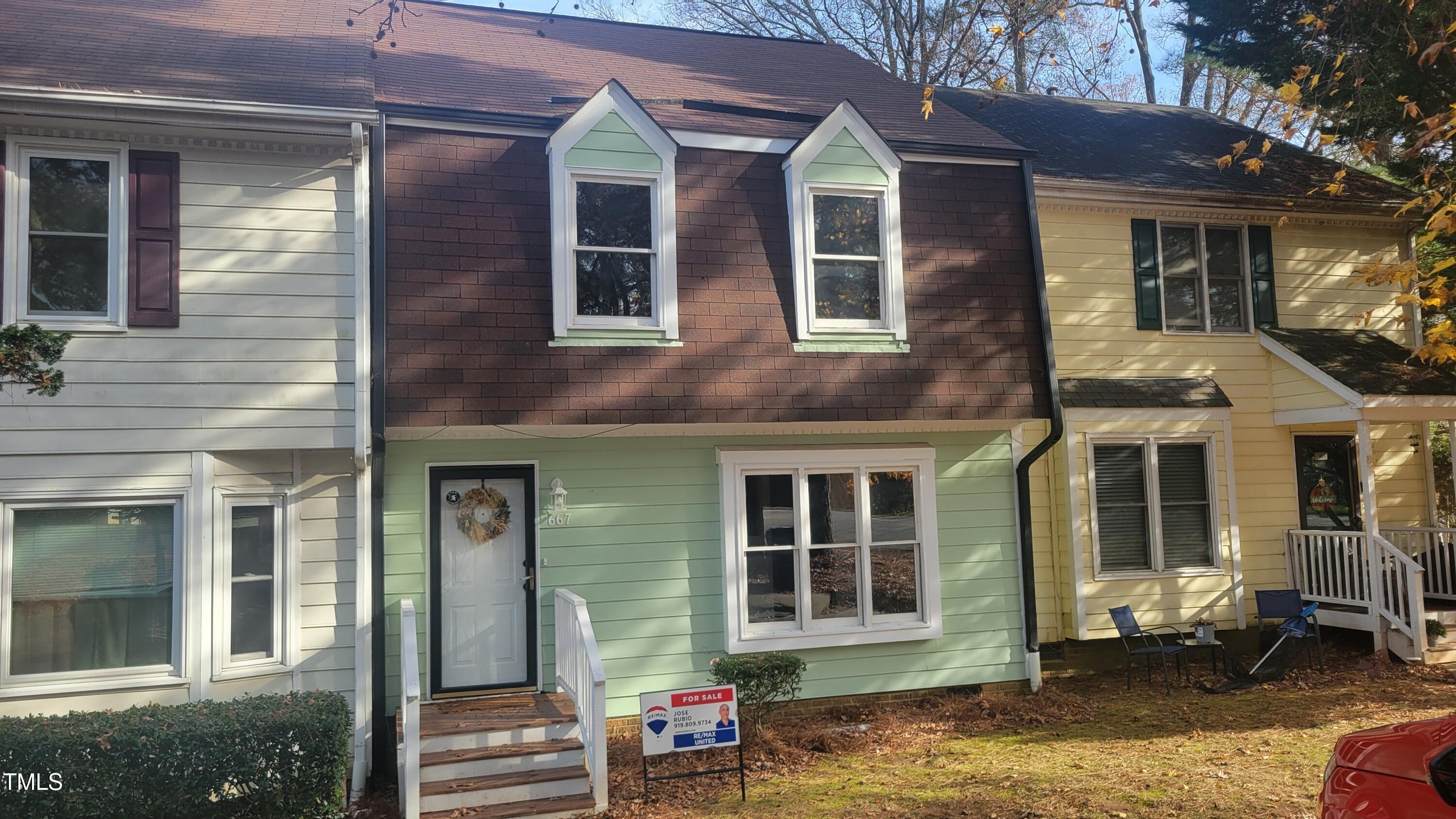 a view of a brick house with a windows and floor to ceiling windows