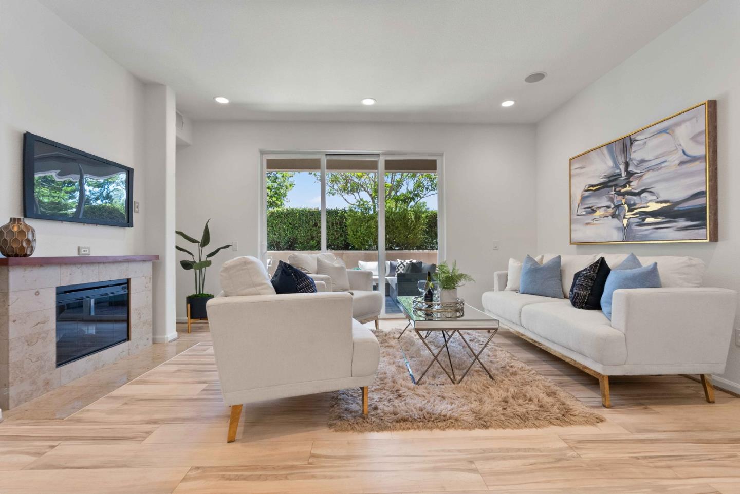 a living room with furniture a fireplace and a flat screen tv