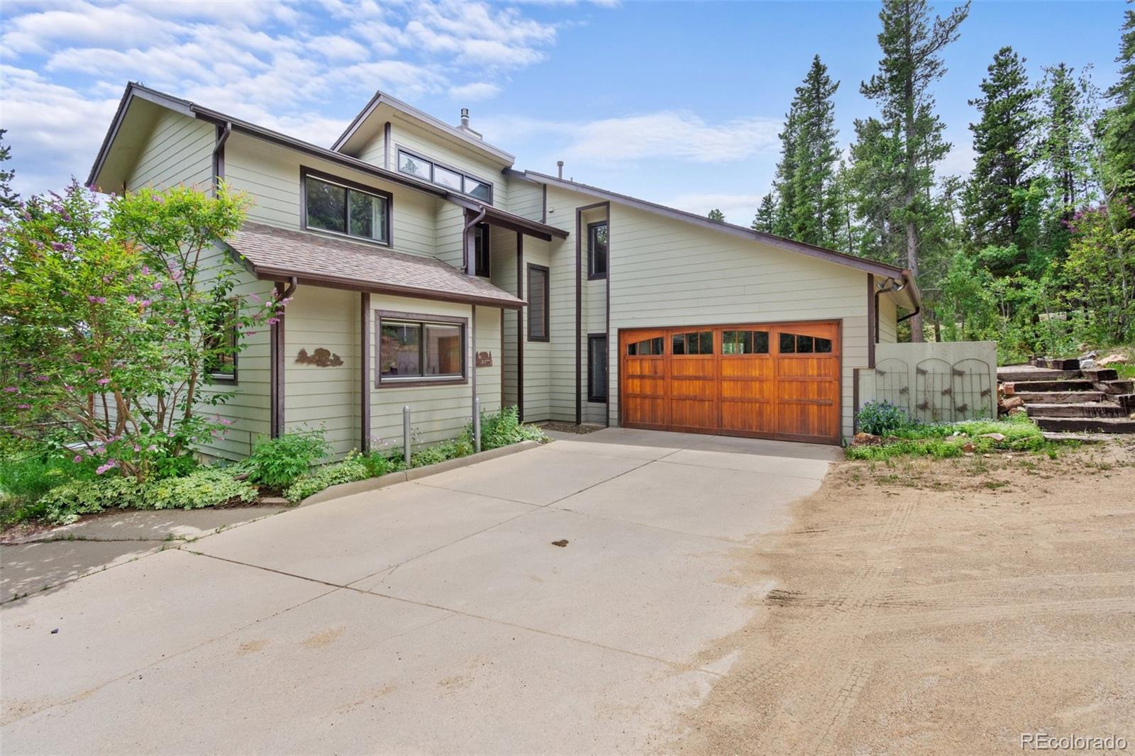 a view of backyard of house and garage