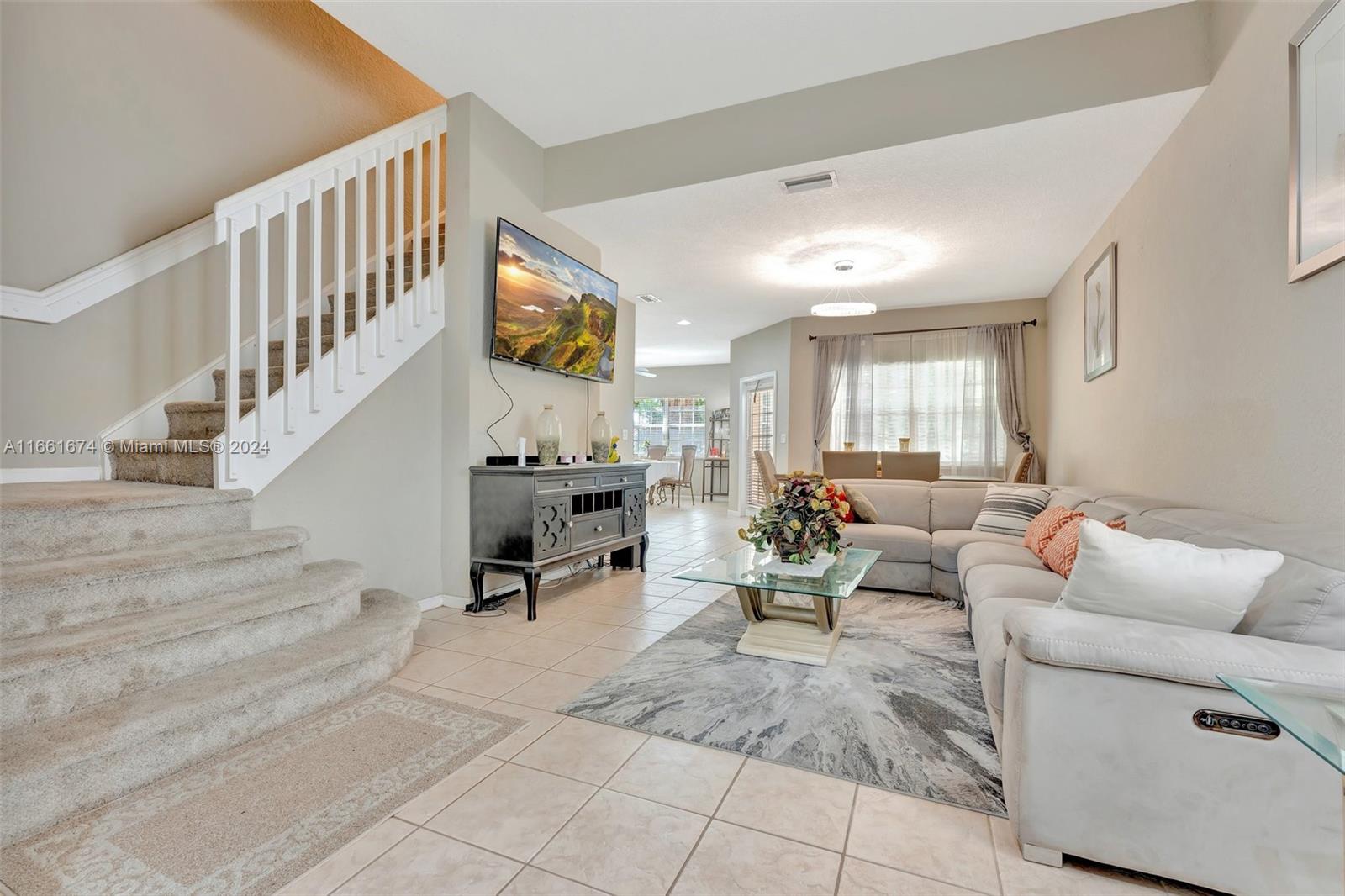 a living room with furniture and stairs