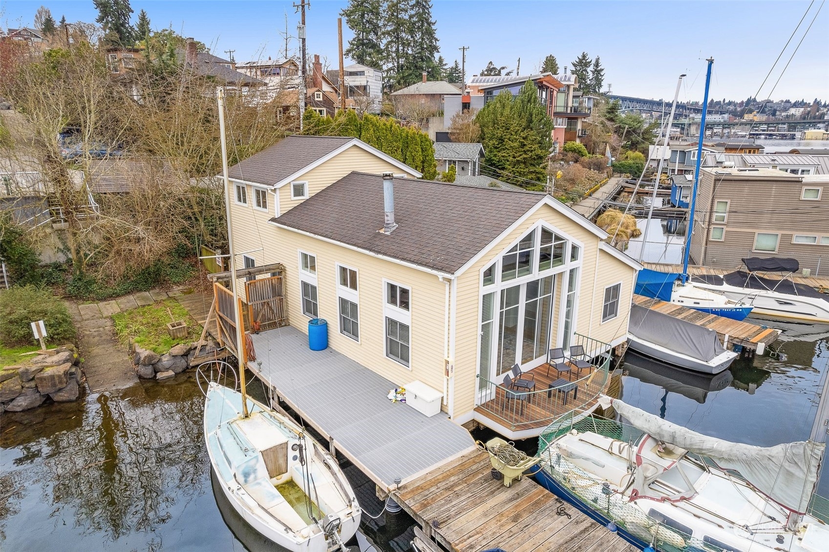 a aerial view of a house with roof deck outdoor seating and yard in the back