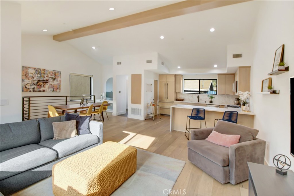 a living room with furniture and kitchen view