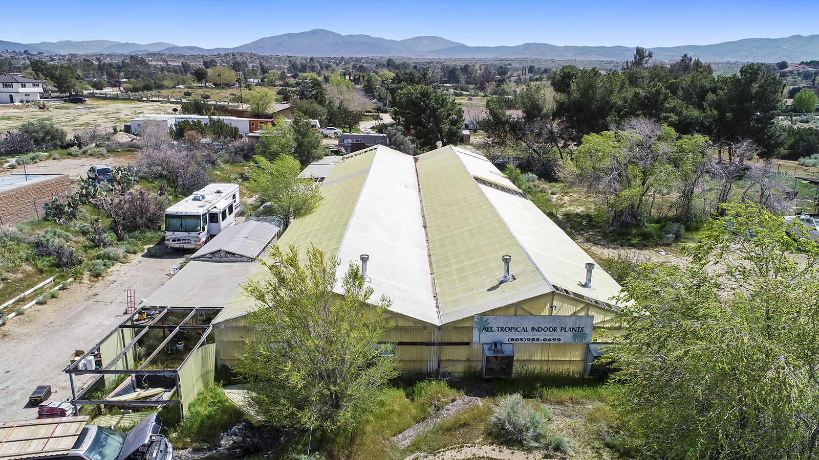 an aerial view of a house with a garden and a mountain view