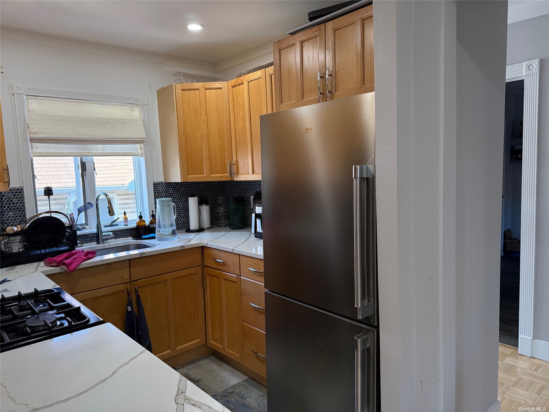 a kitchen with stainless steel appliances granite countertop a refrigerator and a sink