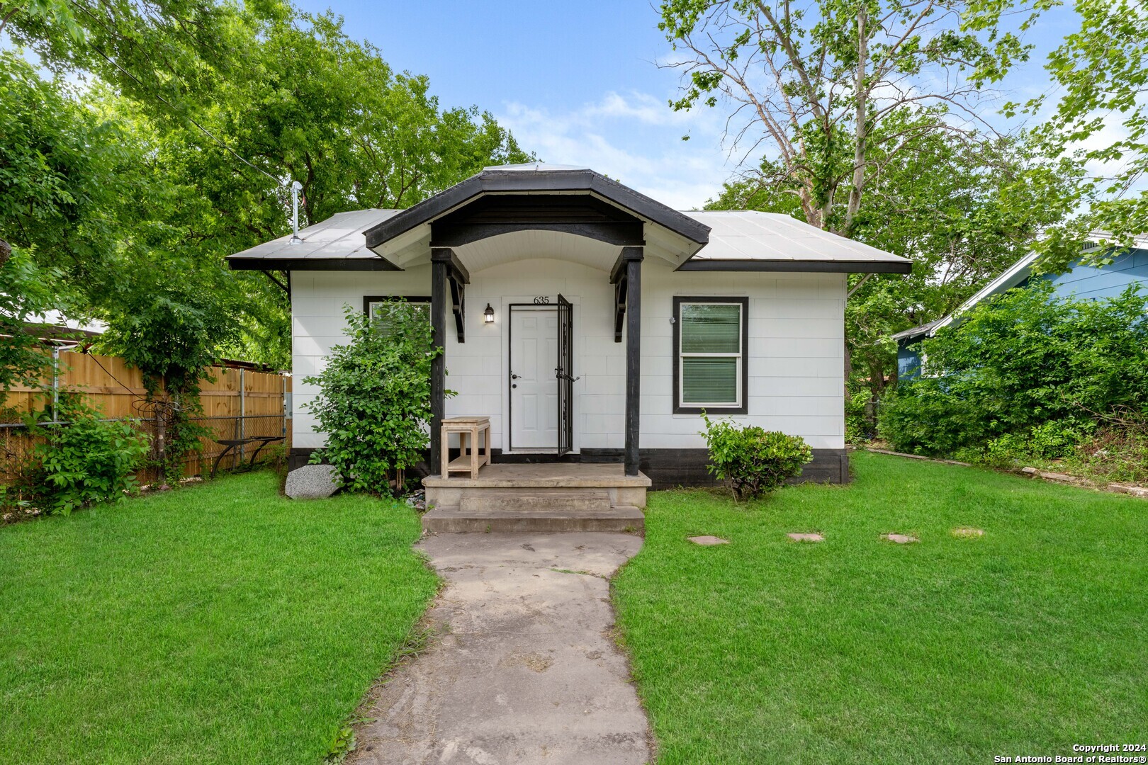 a front view of a house with garden