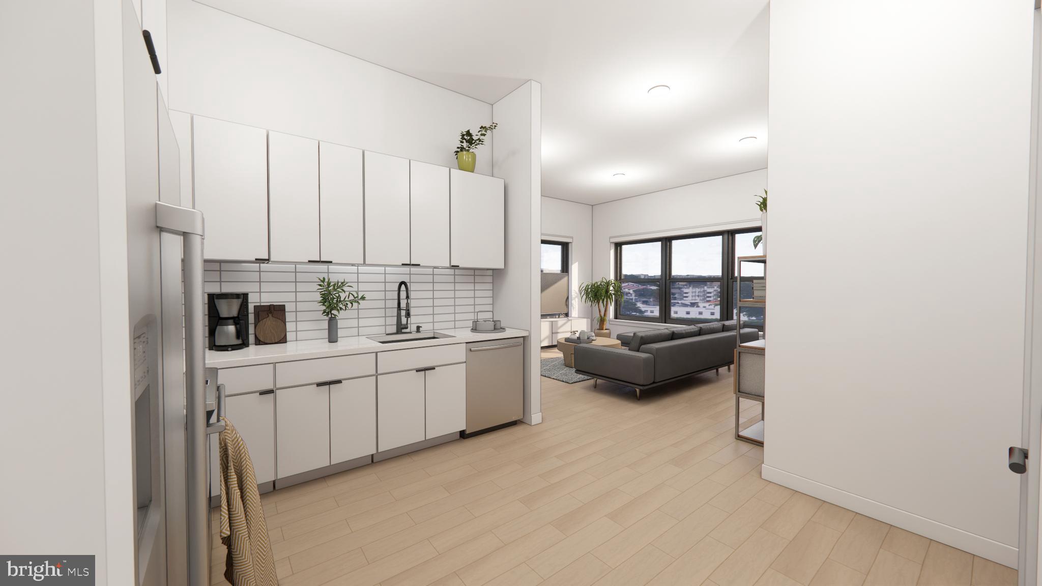 a kitchen with white cabinets and window