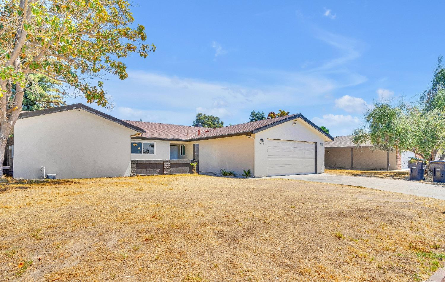 a large house with a yard and garage