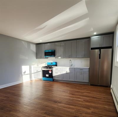 a kitchen with stainless steel appliances a refrigerator and a stove top oven