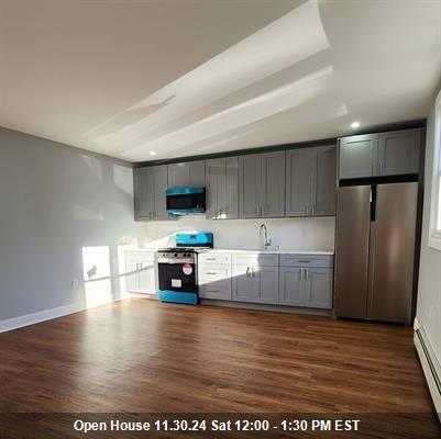 a kitchen with stainless steel appliances a refrigerator and a stove top oven