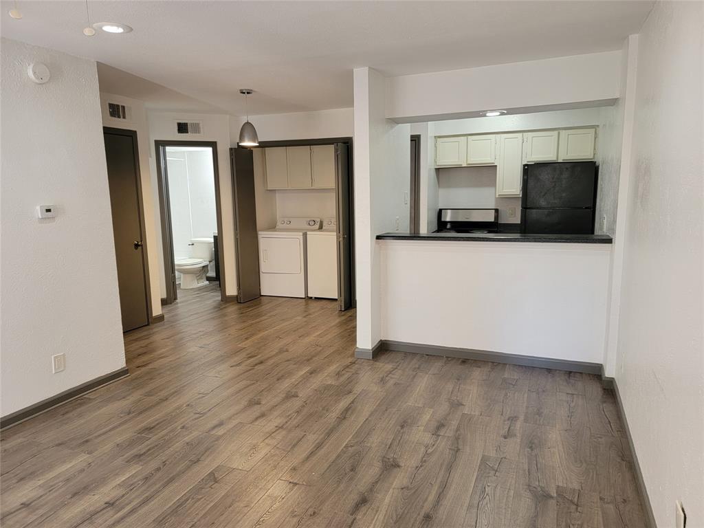 a view of a kitchen with a sink and a refrigerator