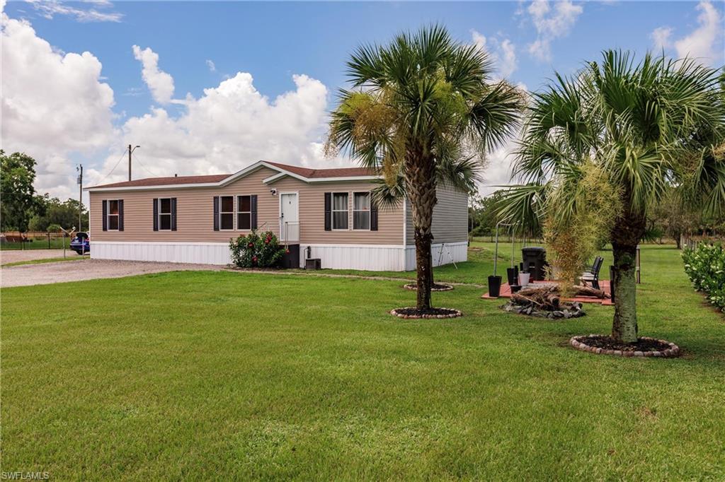 a front view of house with yard and green space