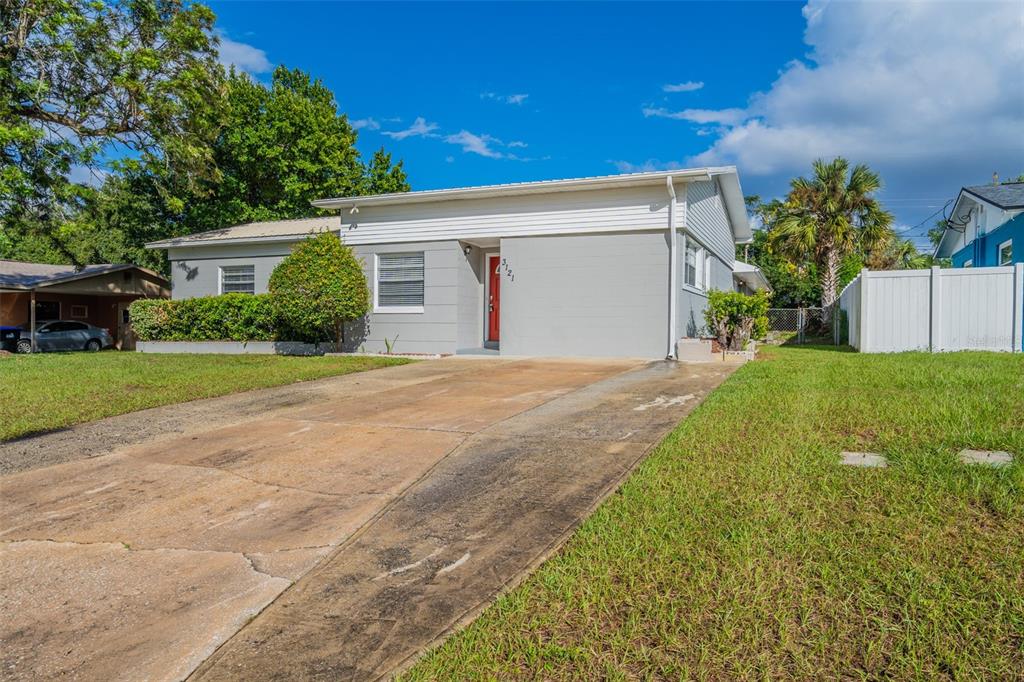 a view of a house with a yard and garage