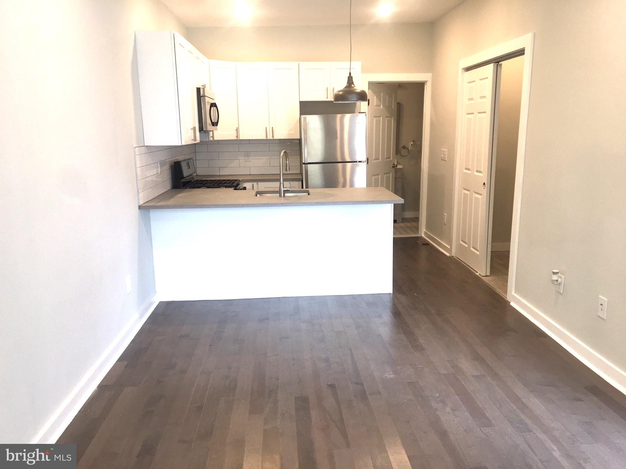 a view of kitchen with wooden floor