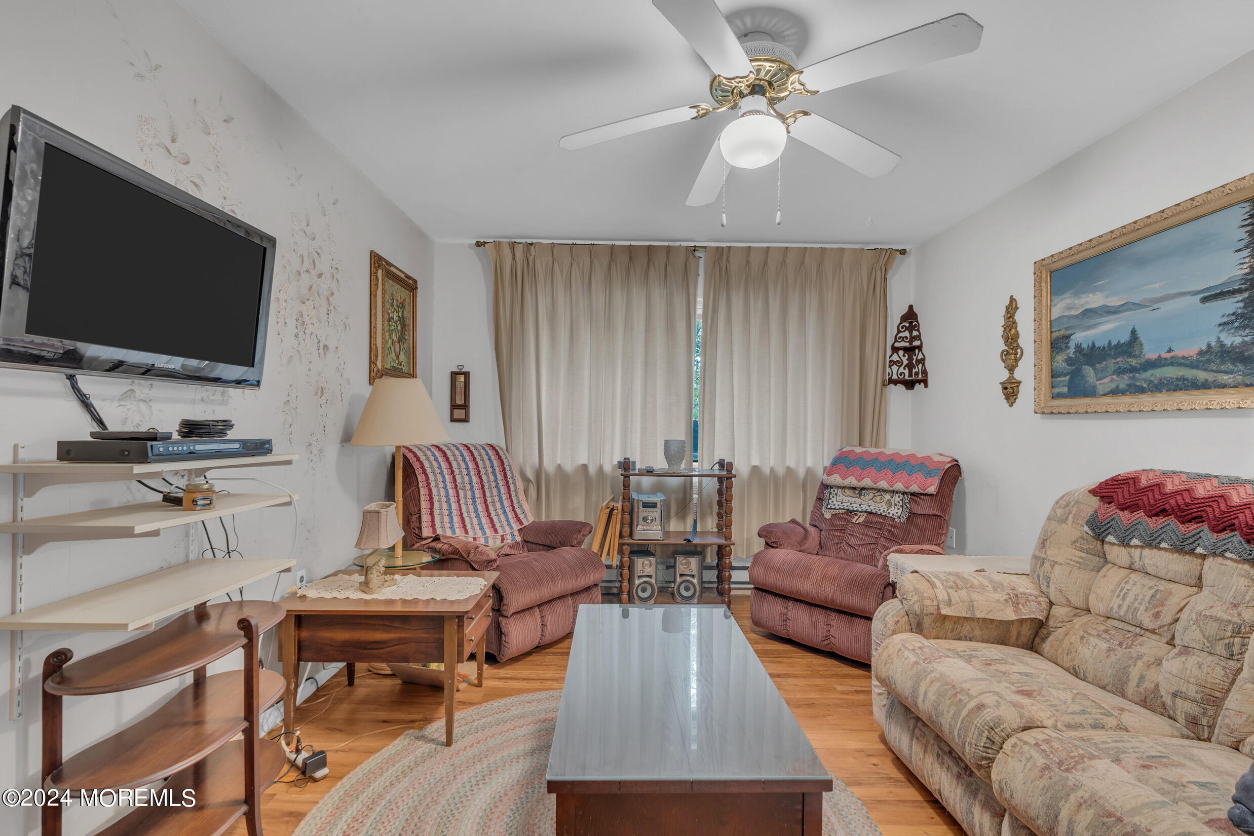 a living room with furniture and a flat screen tv