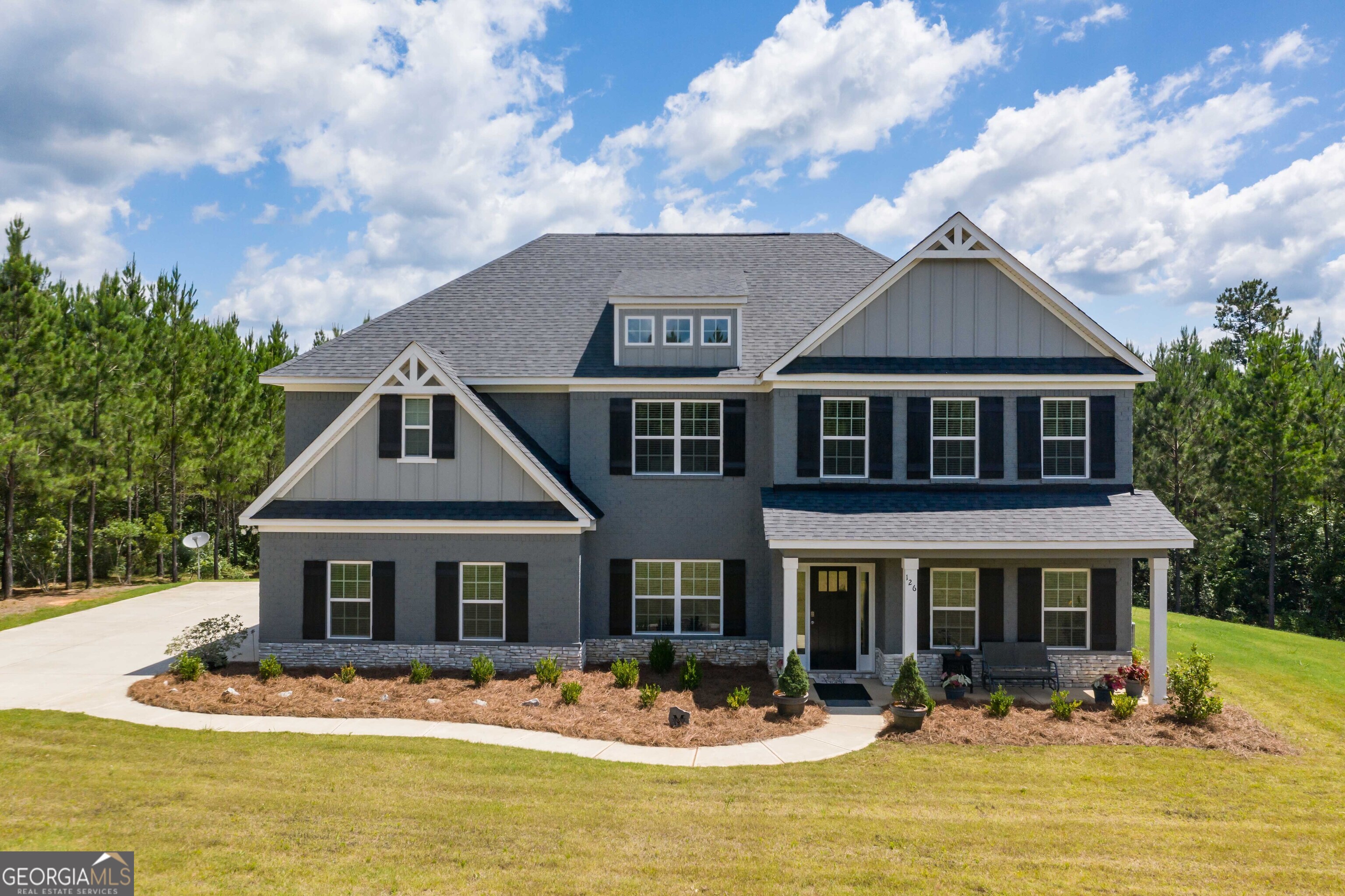 a front view of houses with yard